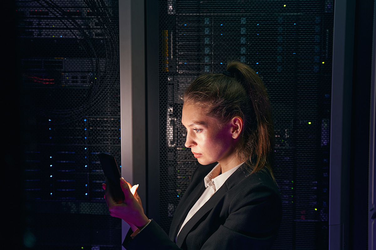 woman engineer working in data center by server